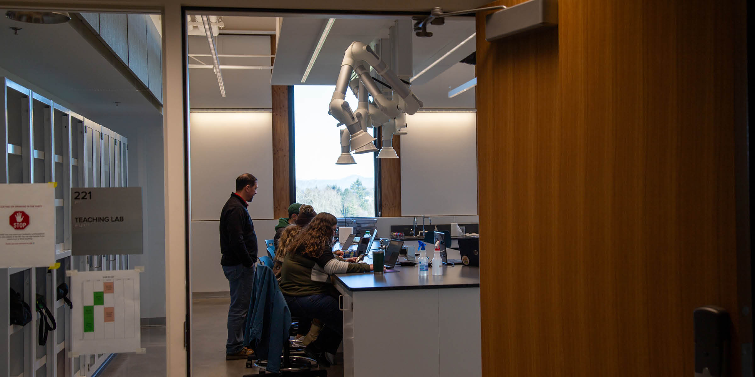 A group of students collaborating and working inside a modern engineering or robotics lab space