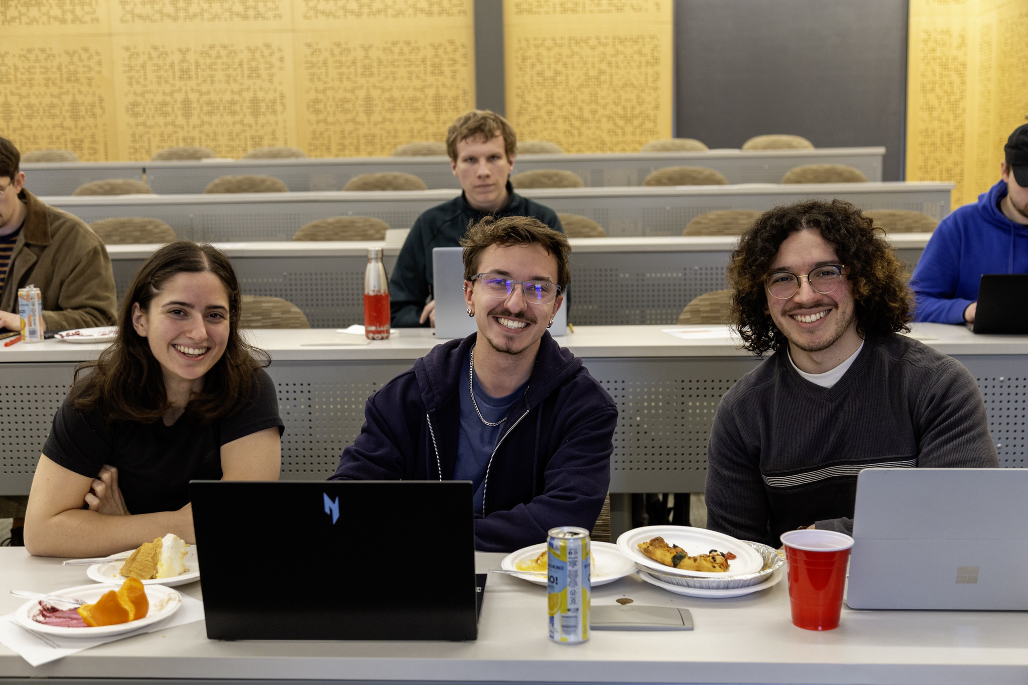 WSU Vancouver students listening and taking notes during a presentation in an auditorium lecture