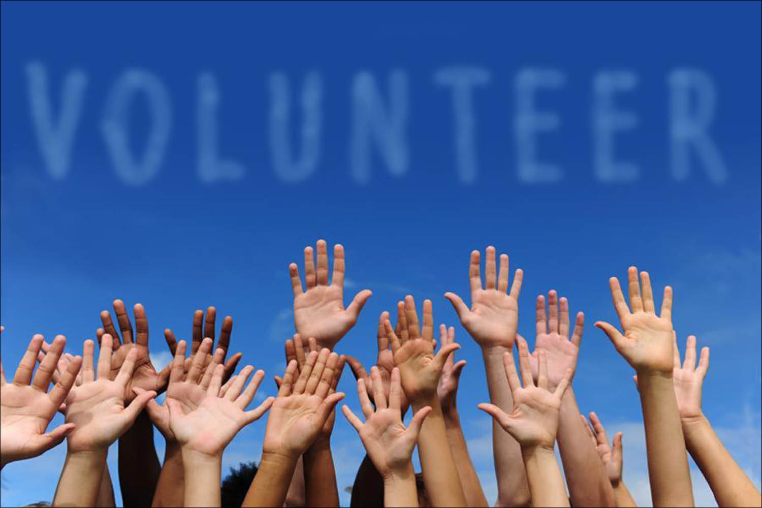 Many hands raised up in front of a blue background with the word VOLUNTEER