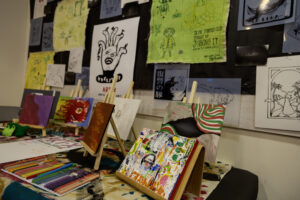 An art studio or classroom display filled with drawings and posters