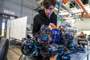 WSU Vancouver engineering students building and assembling a complex mobile robotics chassis
