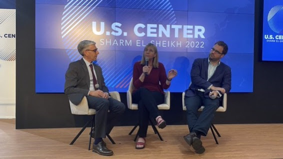 A group of professional presenters taking questions on a stage during a panel event