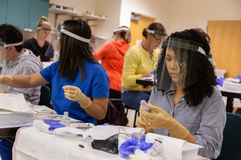 WSU Vancouver nursing or science students working together with samples at a lab table
