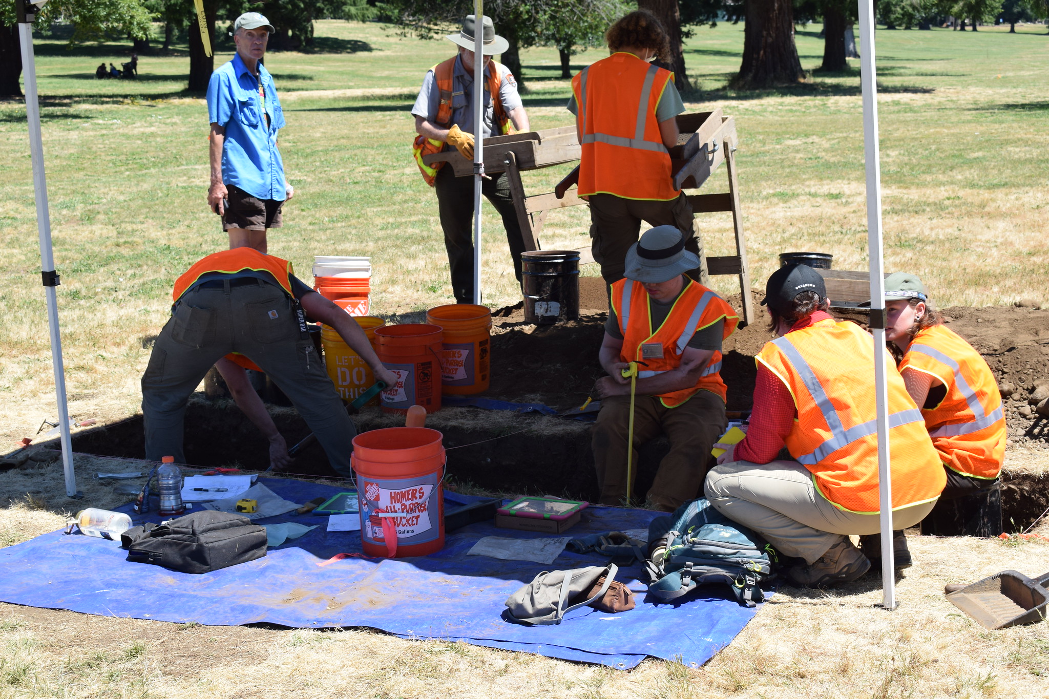 A group of field researchers wearing safety vests gathering outdoors at a WSU Vancouver field site