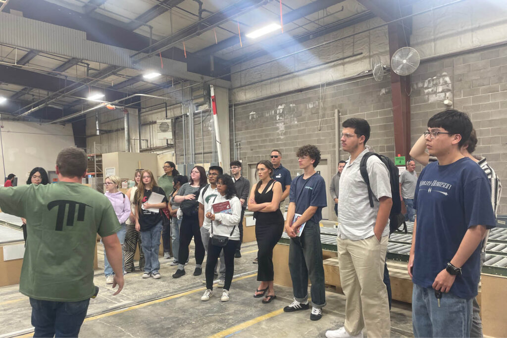 A large crowd of visitors and students gathering for an event inside a WSU Vancouver campus facility