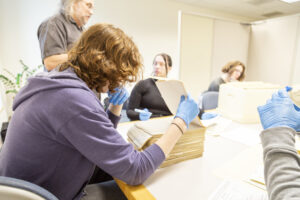 A WSU Vancouver student focusing on notes and documents at a quiet library desk