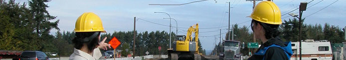 Researchers pointing at construction equipment