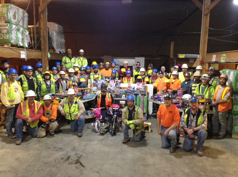 Construction crew posing with toy donations.