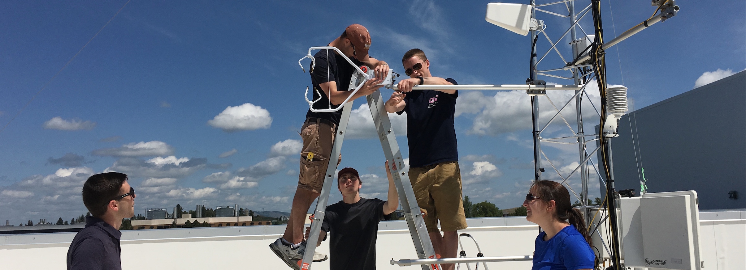 students installing LAR weather station