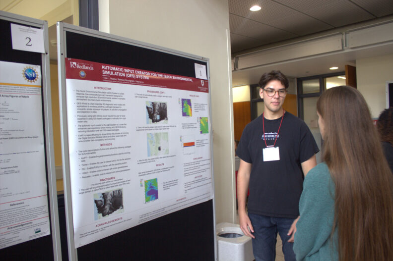 Student presenting project to another student.