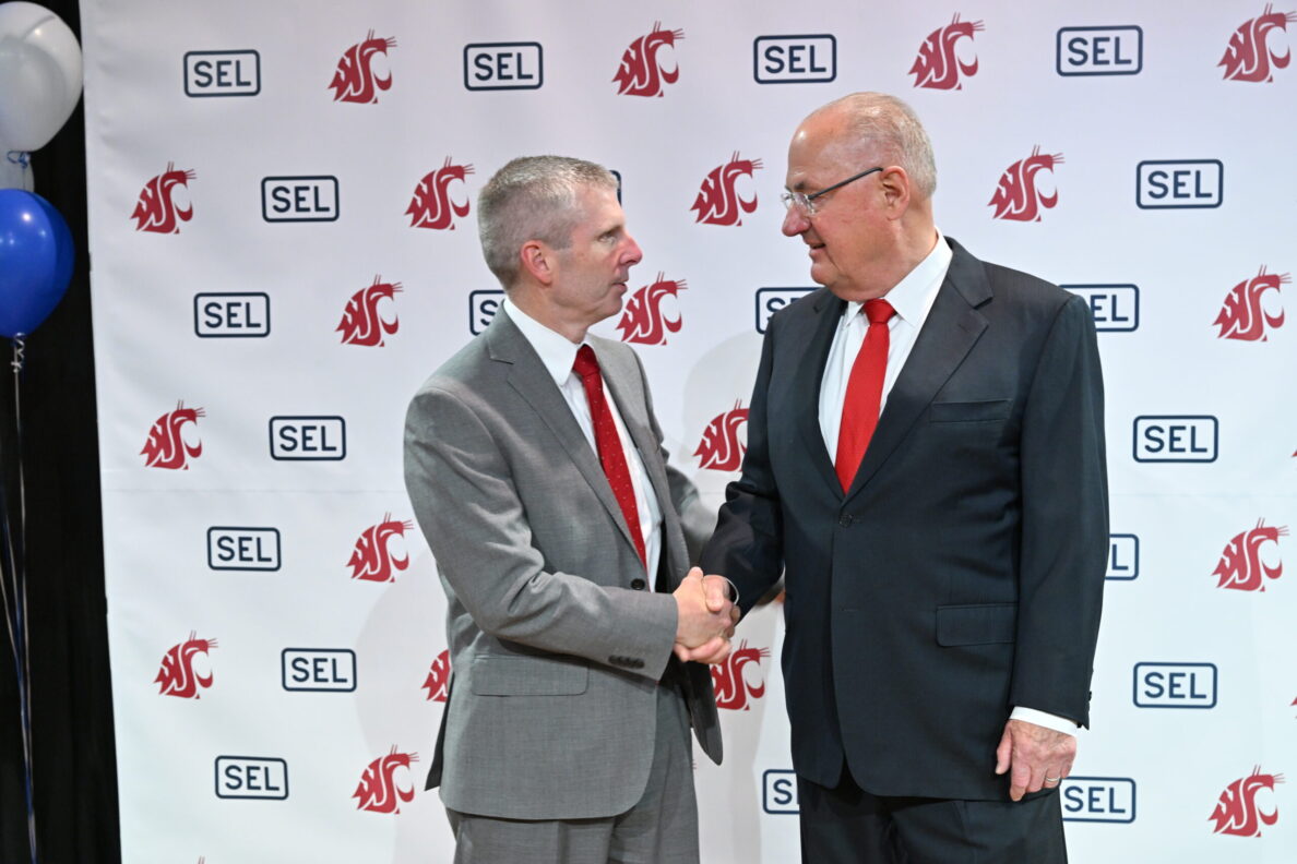Dave Whitehead and Ed Schweitzer shaking hands.