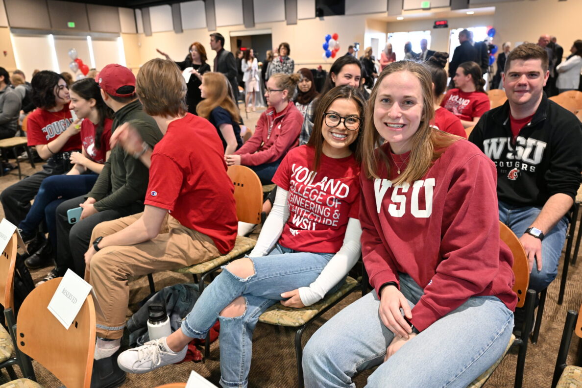 Students waiting in an auditorium.