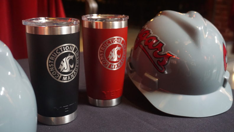 Construction Management coffee cups and hard hat with "cougar0s" written on it.