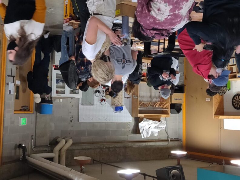 Students working with tools in a classroom.