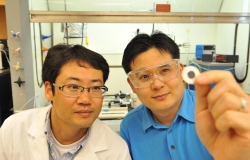Professor Su Ha and student Byeong Wan Kwon holding fuel cell