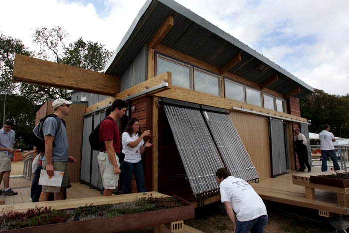 Washington State University team members show off their evacuated-tube collectors for the home's solar hot water system. The students are participating in the Department of Energy's Solar Decathlon on the National Mall. Photo by Stefano Paltera /Solar Decathlon