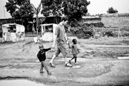 Man walking with two small boys.