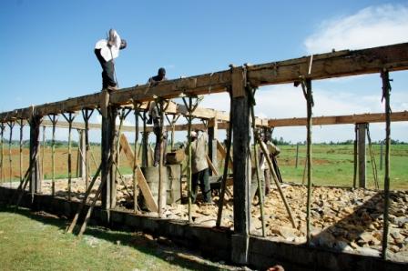 Men raising a building.