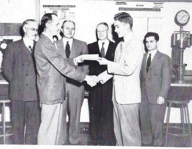 Ronald Nelson receiving scholarship check.