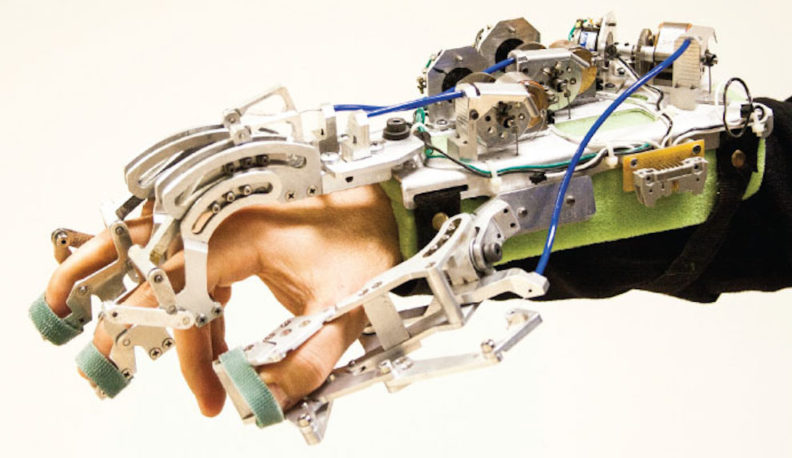 Hand and forearm covered by a glove made of metal and wires.