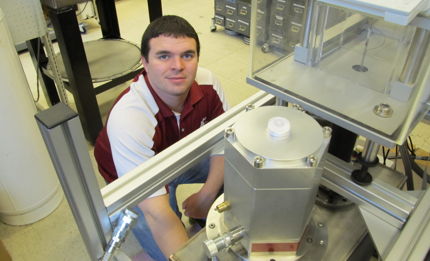 Ian Richardson kneeling by equipment in the research lab.