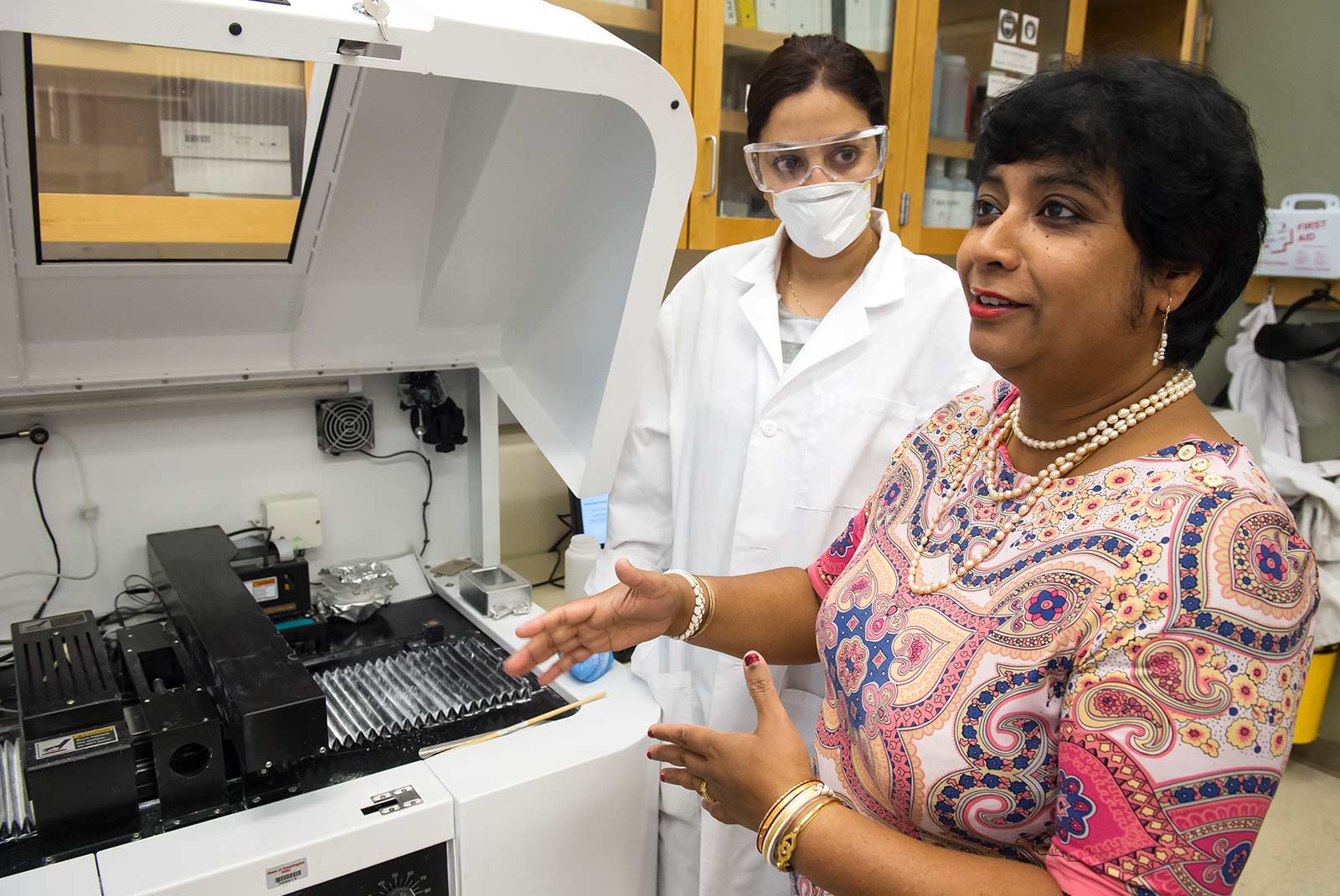 Susmita Bose discusses her research as research assistant looks on.