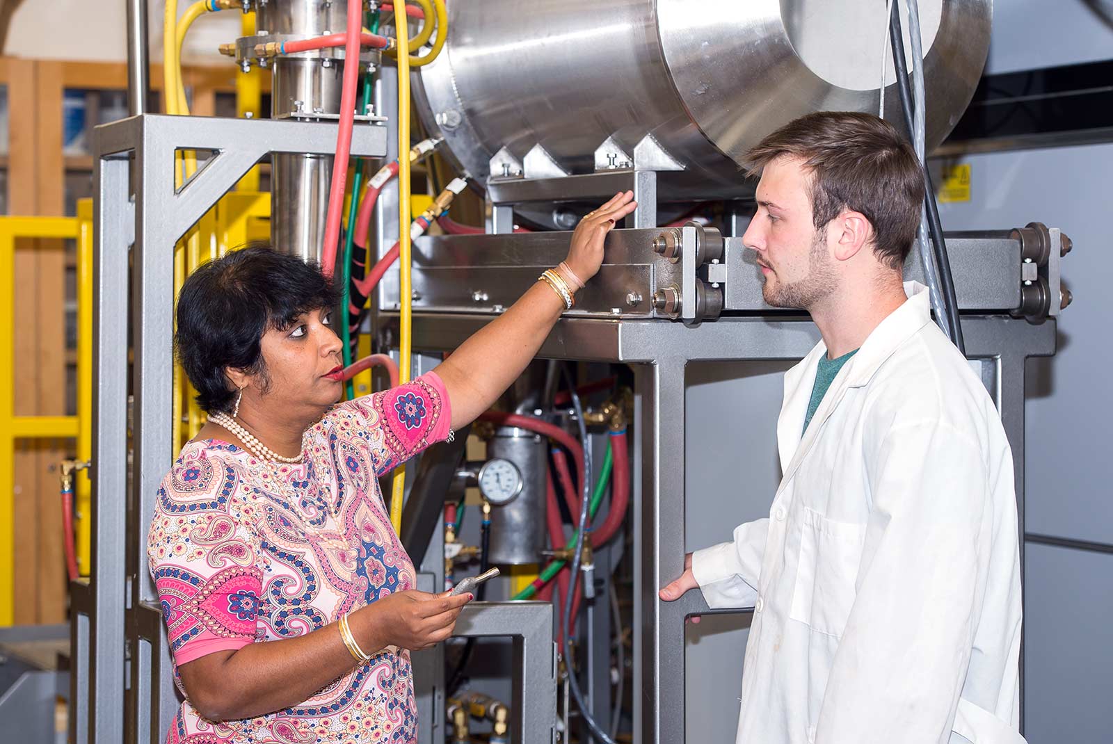 Susmita Bose talking with a student in the lab.