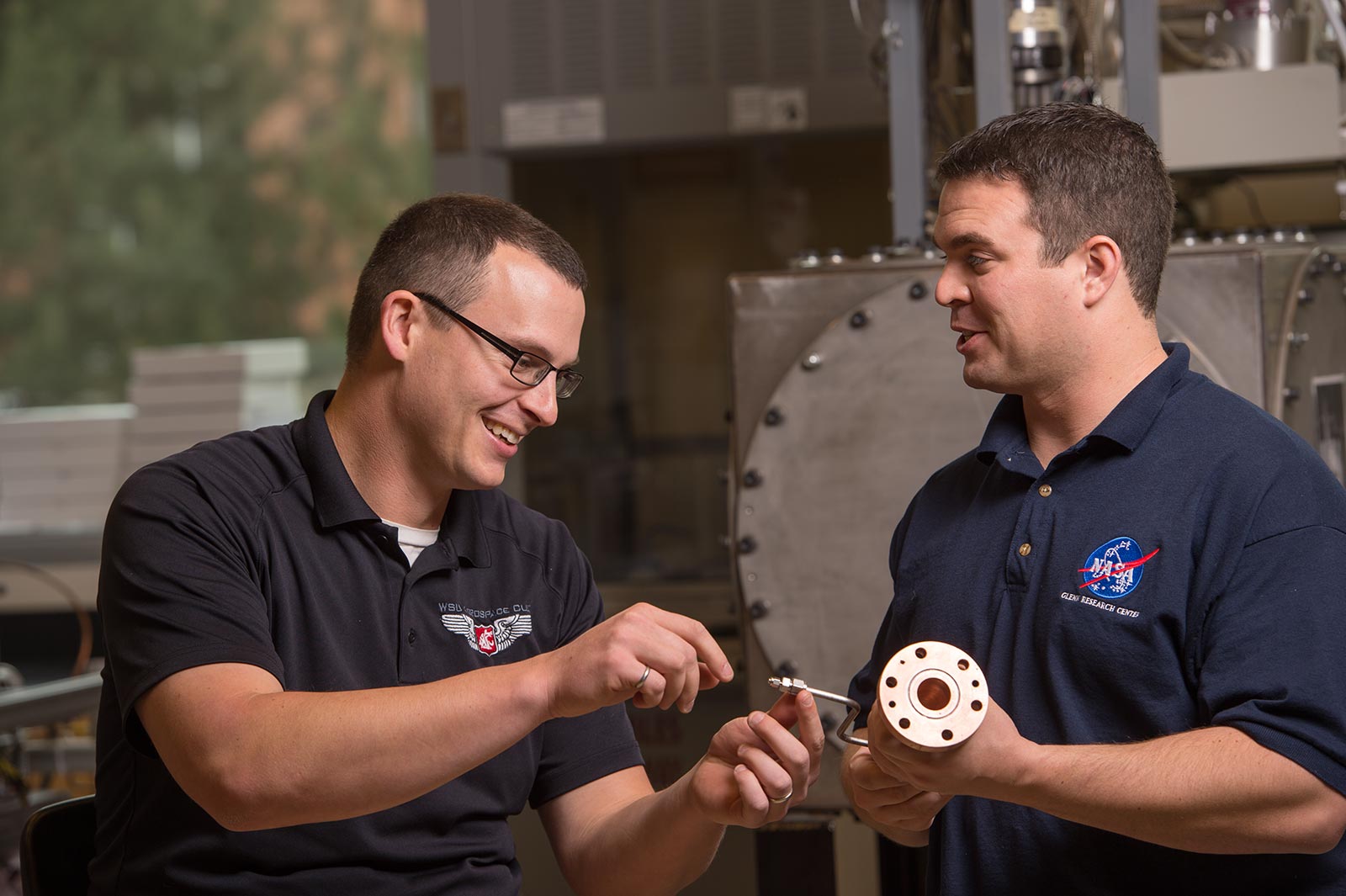 Jacob Leachman and Ian Richardson discuss a machine part.