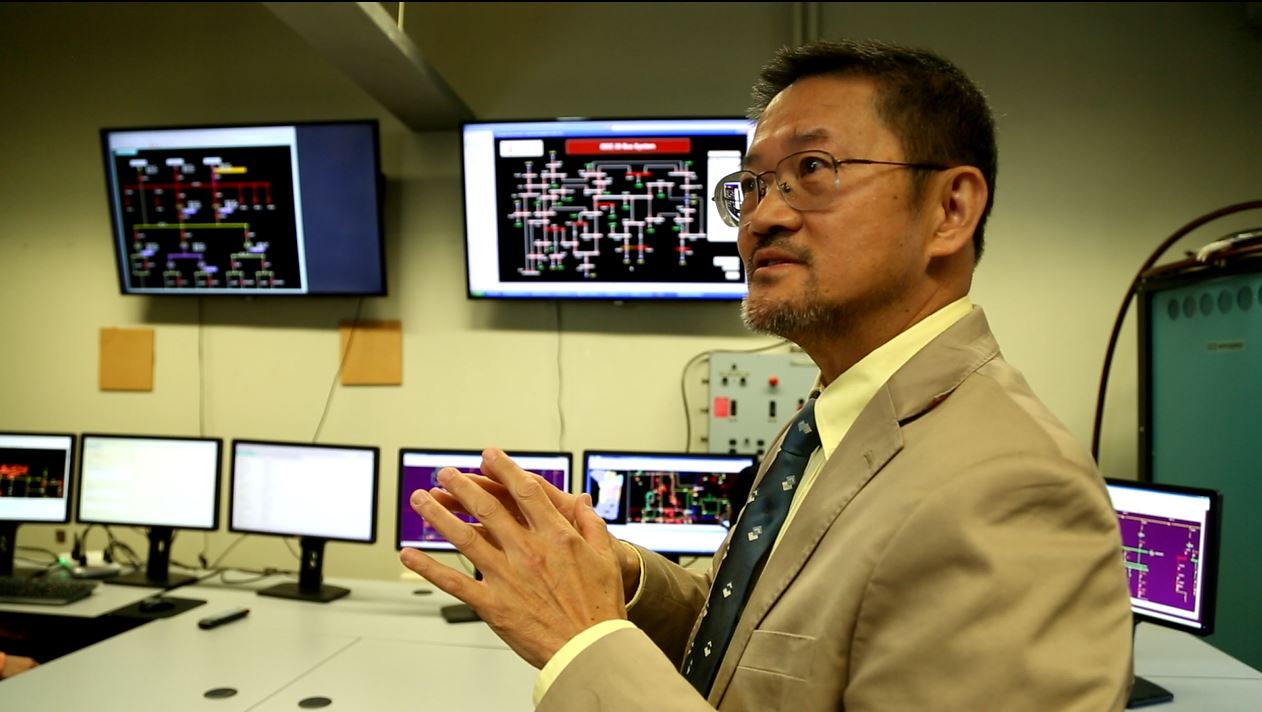 Chen-Ching Liu talking near multiple monitors displaying data.
