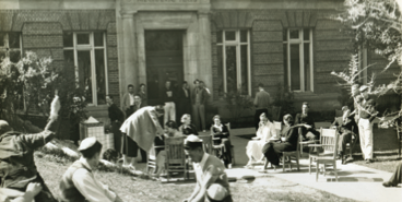 People visiting outside a building.