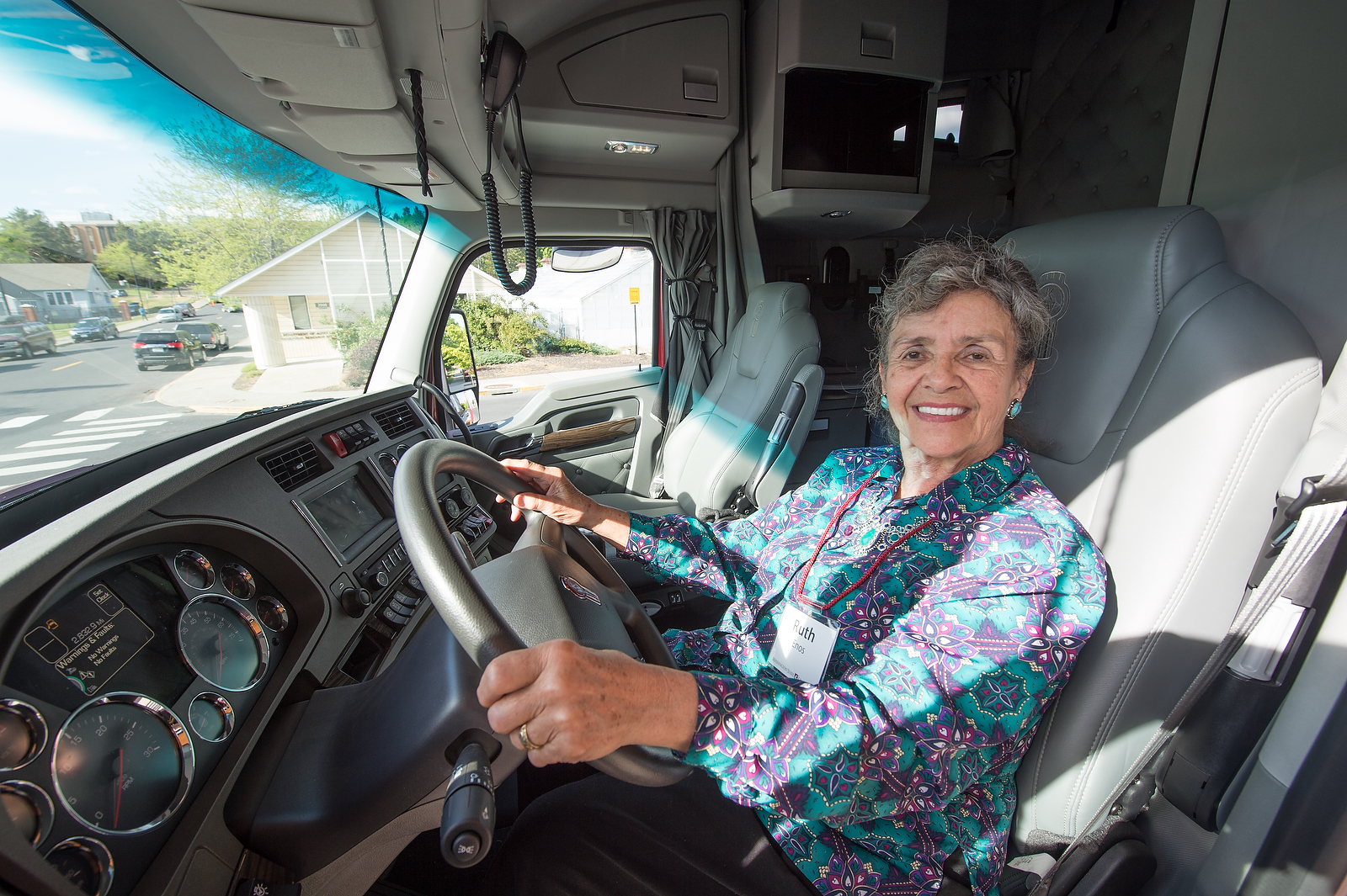 Woman seated at the steering wheel inside a PACCAR truck.