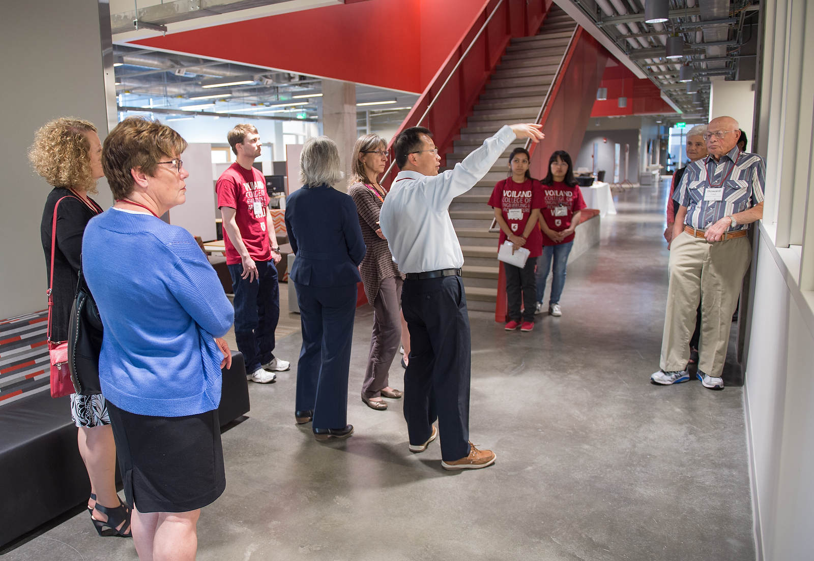 Tour group listening to a guide inside a building.