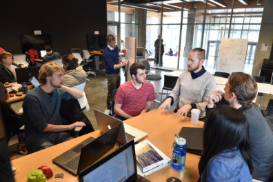 Professor Darrin Griechen works with students on solar decathlon design.