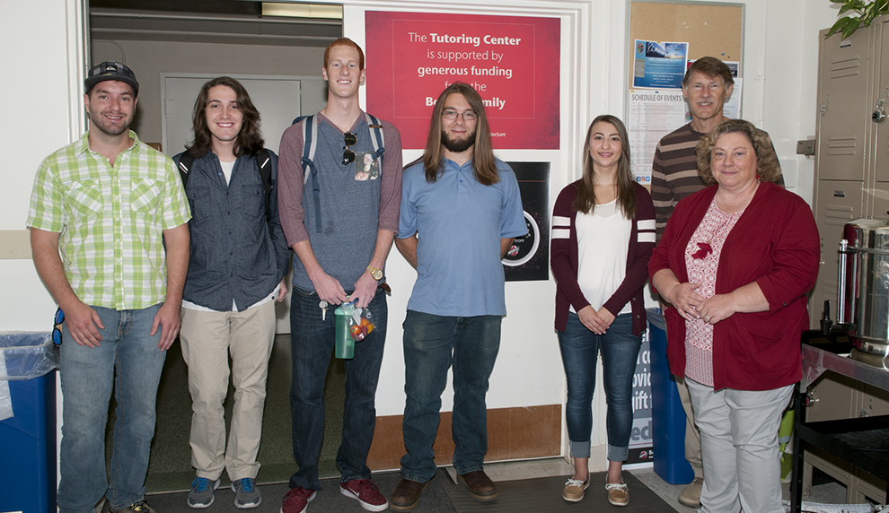 Five tutors pose with donors Jack and Karen Bowers in the tutoring center.
