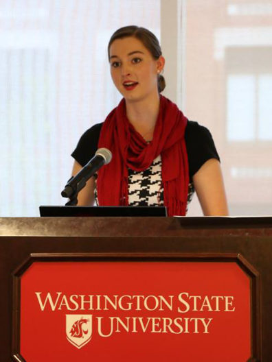 Alyssa Norris standing at a podium.