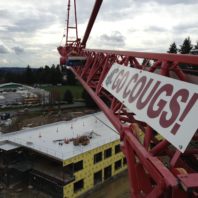 'Go Cougs!' sign on a construction crane.
