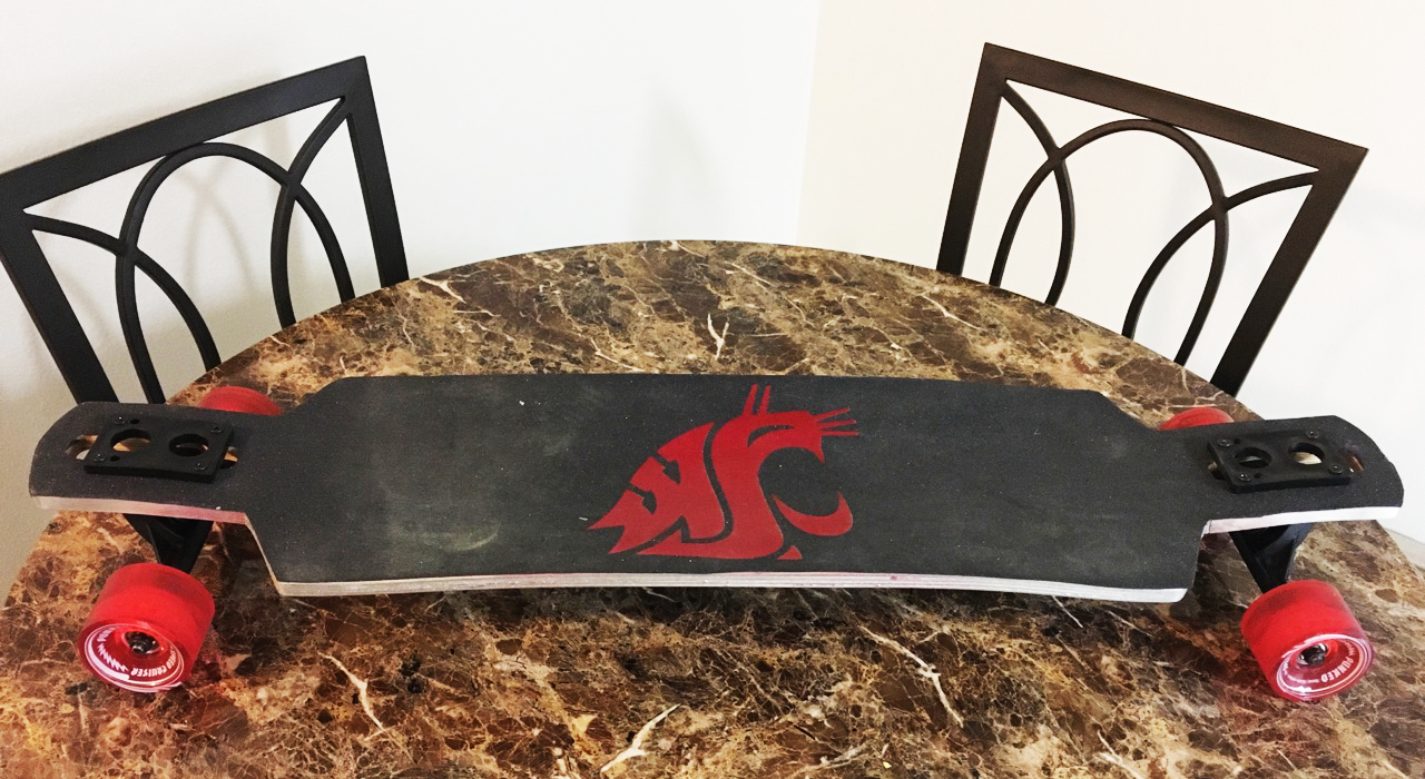 Wood longboard painted black with a crimson WSU Cougar emblem and crimson wheels.
