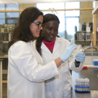 Two students working in a lab.