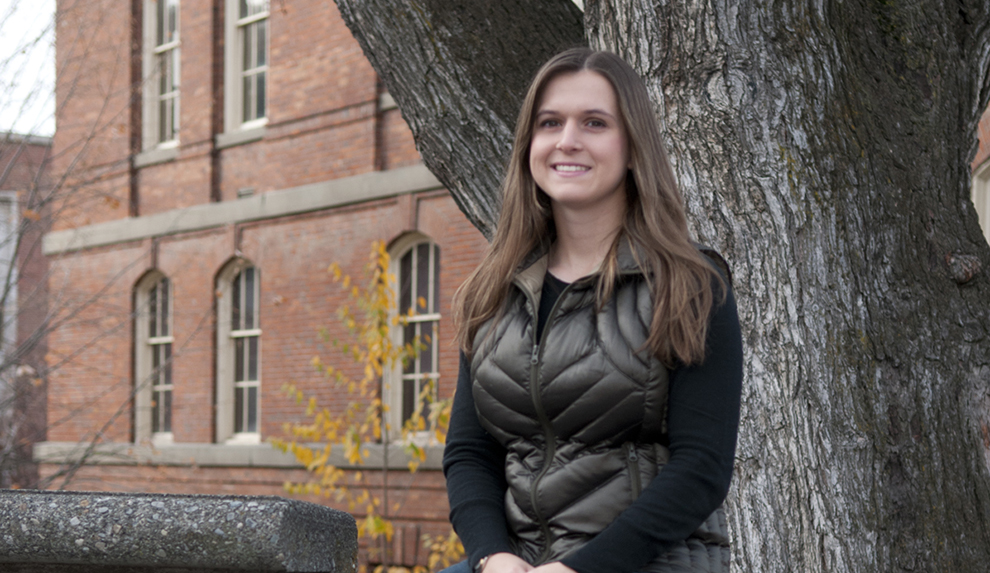Samantha McNicholas sitting by a tree.
