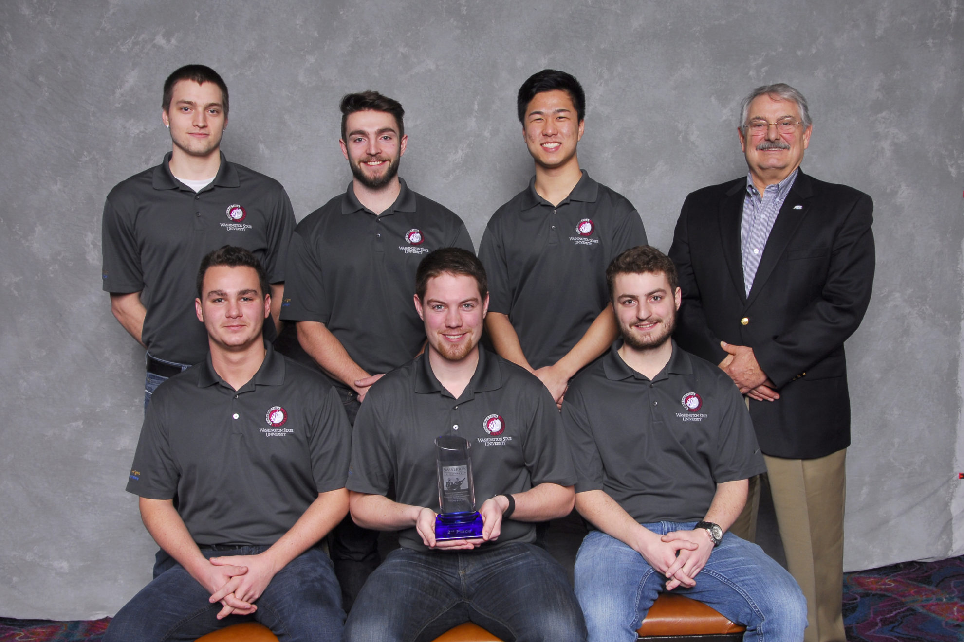 The second-place winning team in the design-build category group photo with their trophy