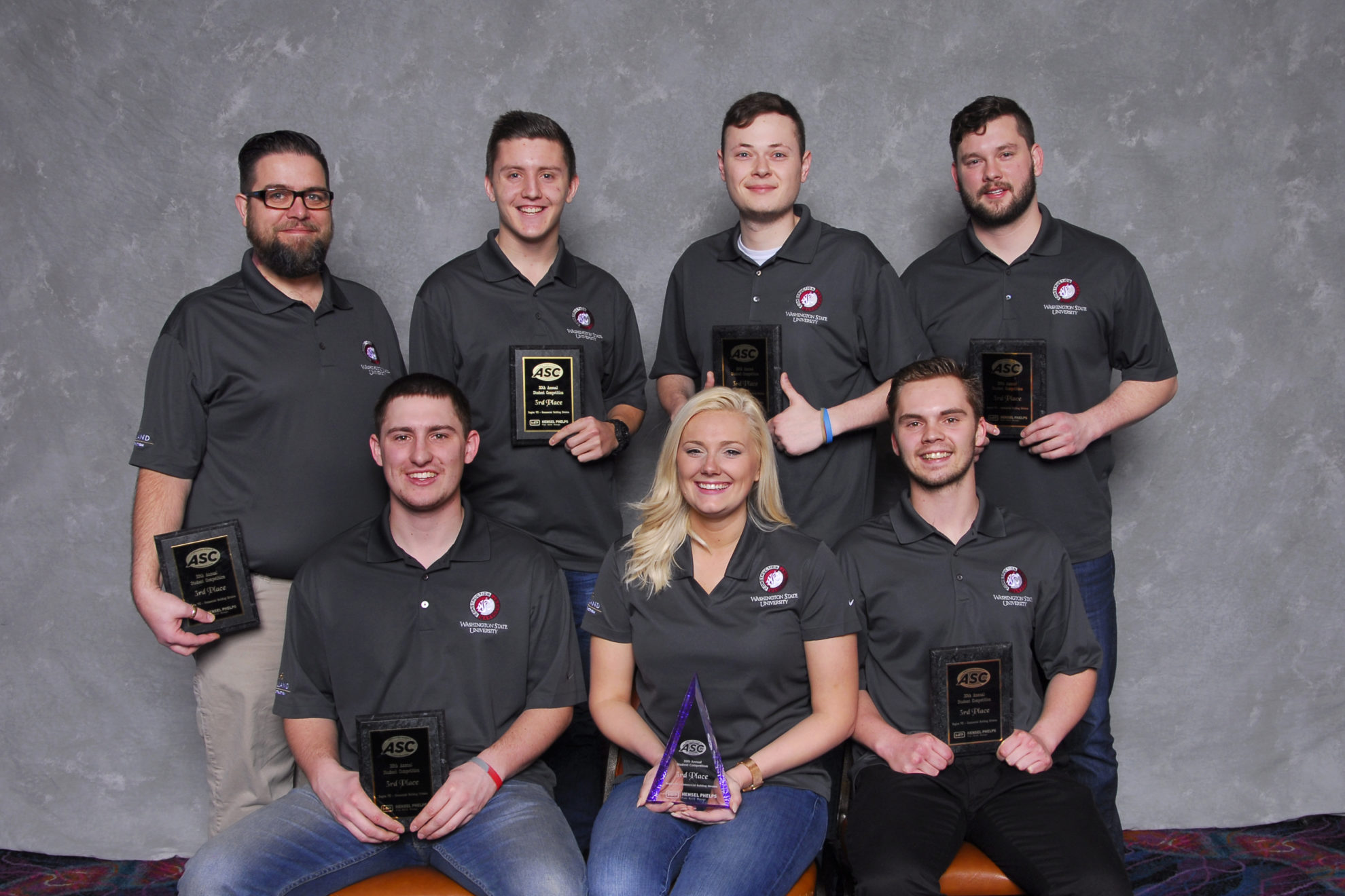 Group photo of WSU's commercial team, placed third in the design-build category with their trophies