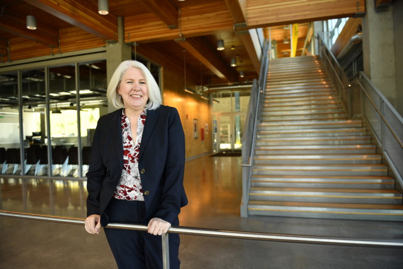 Dean Rezac standing in the lobby of a building with stairs in the background.