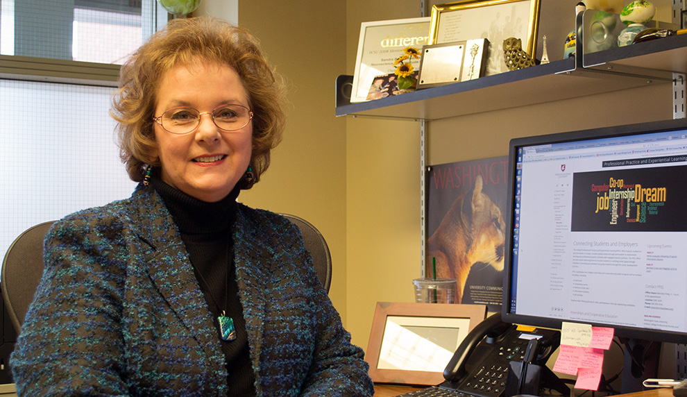 Sandi Brabb sitting at her desk.