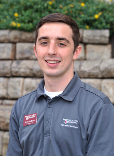 Kevin Wolfrom stands next to a wall