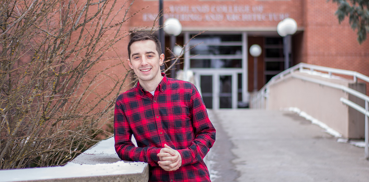 Kevin Wolfrom standing in front of the Voiland College.