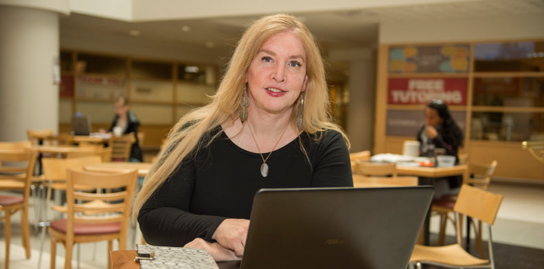 Nella Ludlow seated at her computer.