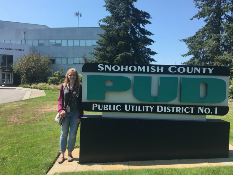 Mary next to a sign that reads Snohomish County PUD Public Utility District No 1.