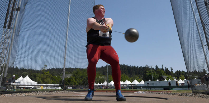 Action shot of Brock Eager swinging the metal ball during a hammer throw competition.