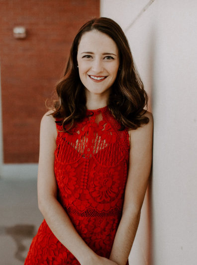 Kelley Sindelar posing in a red dress.