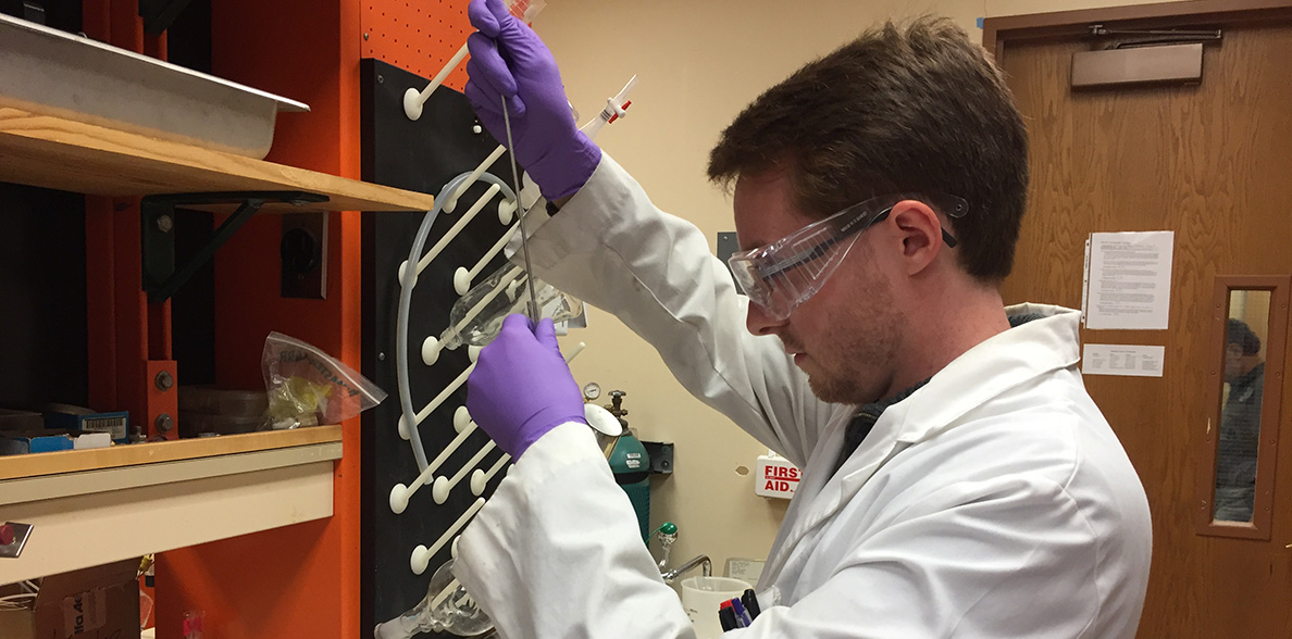 Jake Gray working with chemicals in the lab.